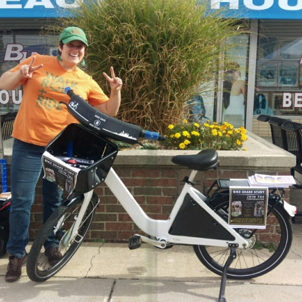 Amanda posing with bicycle for outreach with the bike share feasibility study