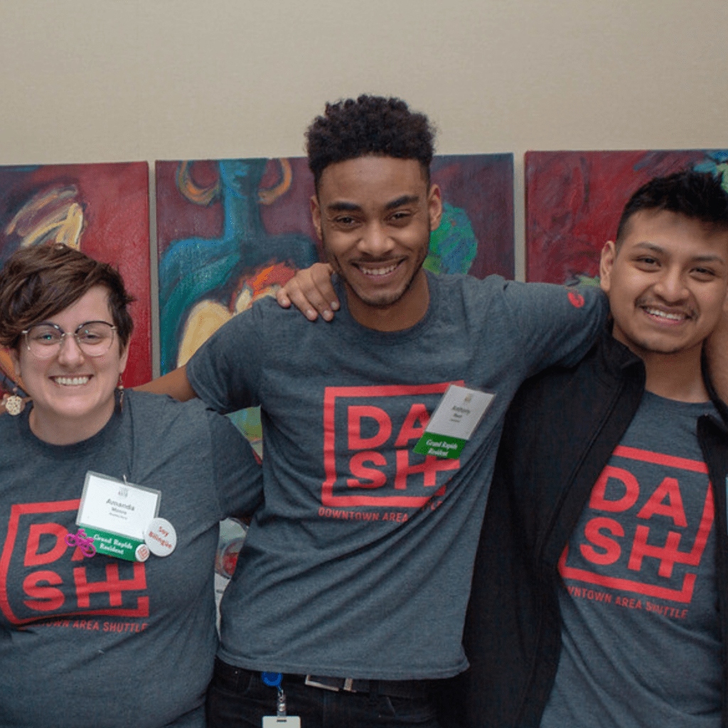 Amanda posing with college interns from Mobile GR's event marketing program.